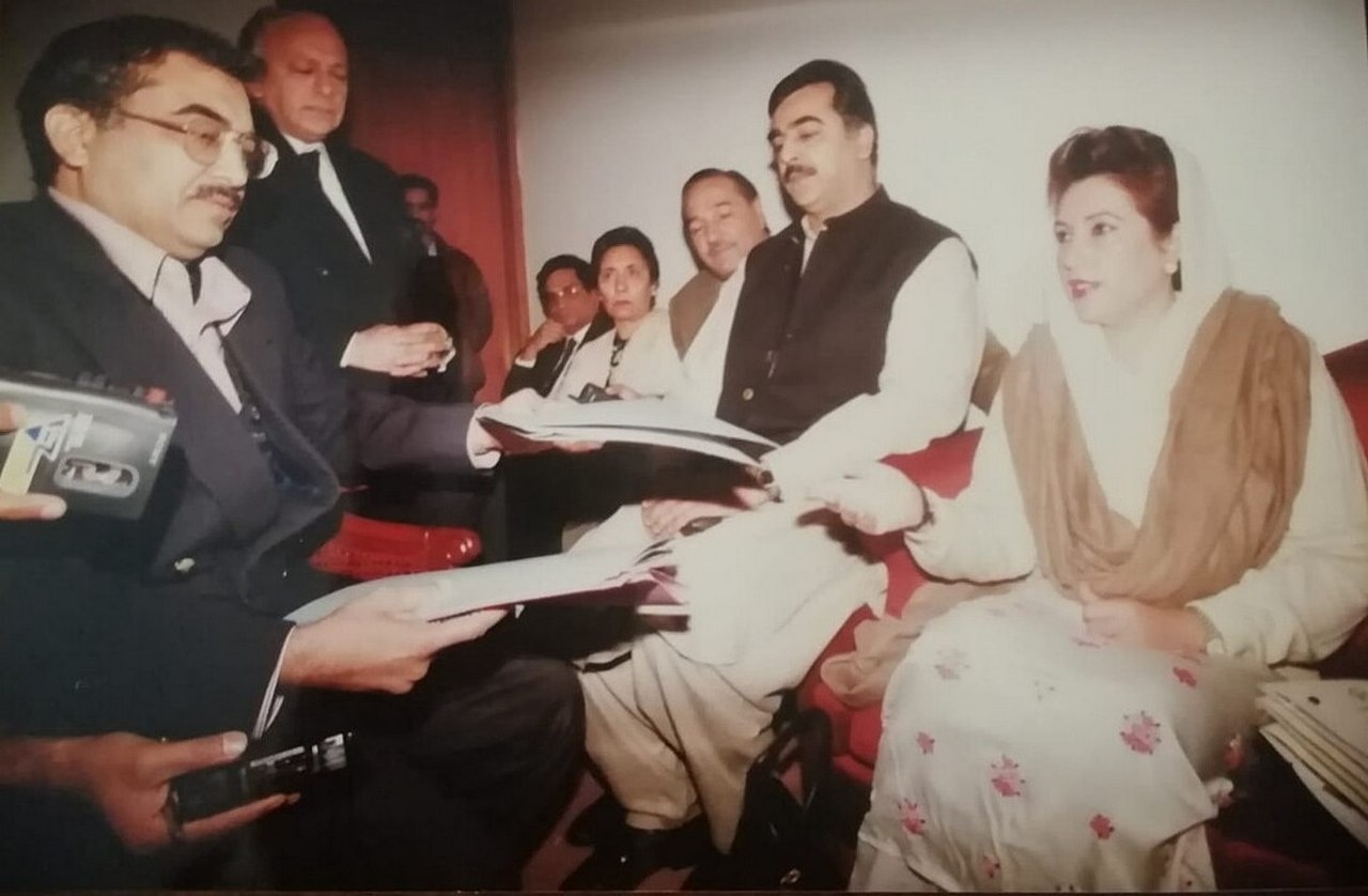 Беназир Бхутто (справа) передаёт документы о коррупции Шехбаза Шарифа директору отдела специальных расследований, Исламабад, 1997 г.